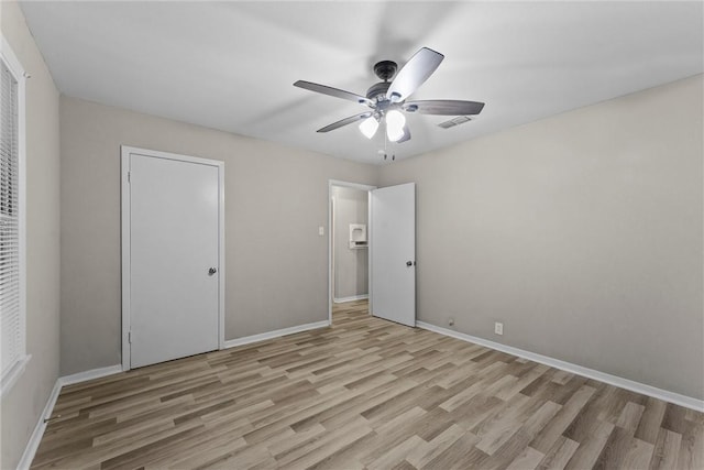 907 Barnhill St, Brenham, TX 77833 - unfurnished bedroom featuring light wood-style floors and a ceiling fan