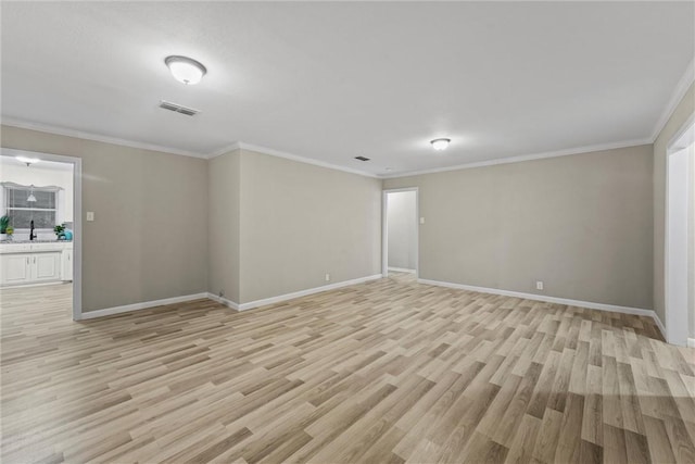 907 Barnhill St, Brenham, TX 77833 - empty room featuring light wood finished floors and ornamental molding