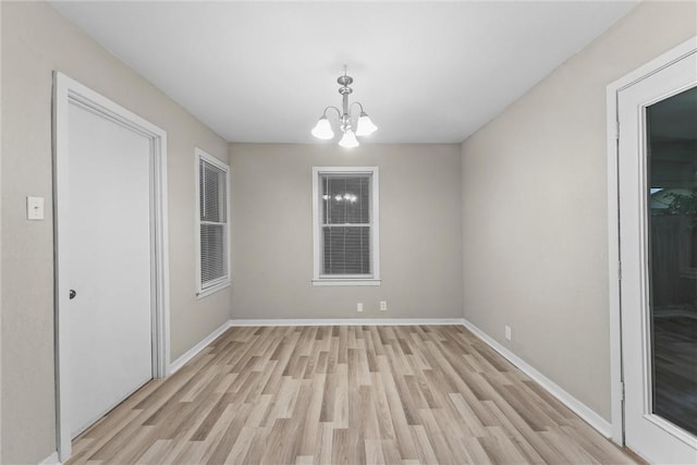 907 Barnhill St, Brenham, TX 77833 - unfurnished dining area featuring light wood-style flooring and a chandelier