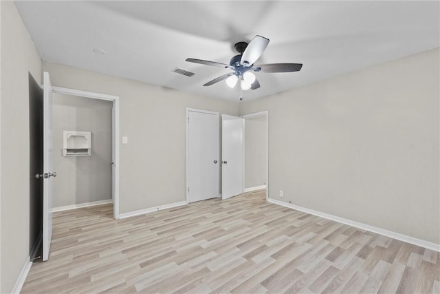 907 Barnhill St, Brenham, TX 77833 - unfurnished bedroom with light wood-style floors and a ceiling fan