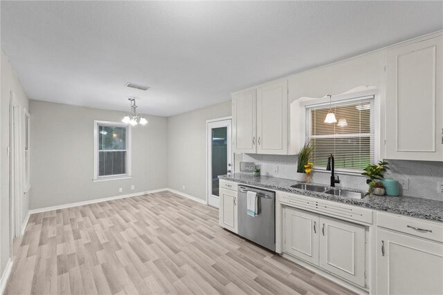 907 Barnhill St, Brenham, TX 77833 - kitchen featuring dishwasher, a chandelier, white cabinets, and light wood-style flooring