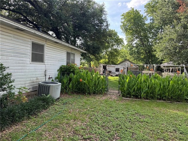 610 Calvert St, Hearne, TX 77859 - view of yard featuring cooling unit and a gate