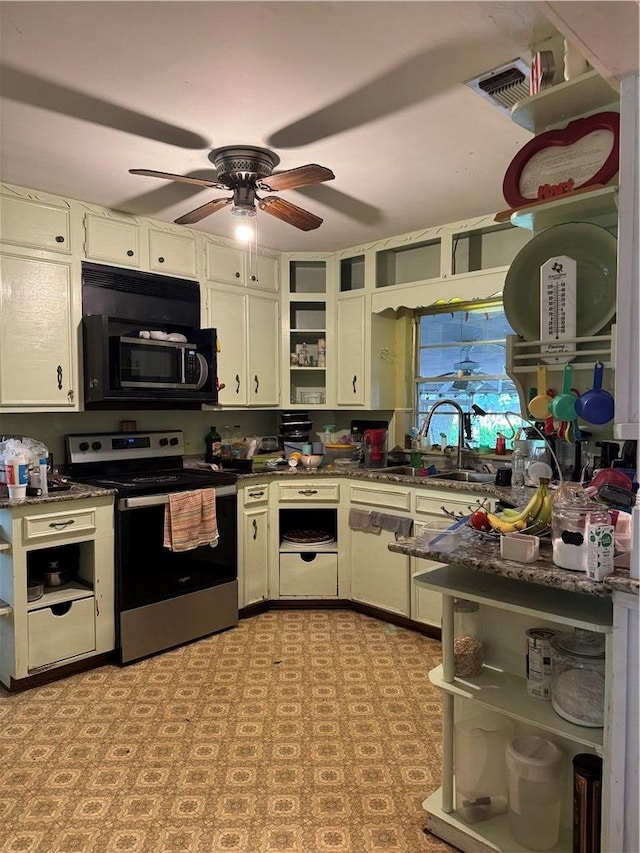 610 Calvert St, Hearne, TX 77859 - kitchen with stainless steel electric range, open shelves, ceiling fan, a sink, and white cabinets
