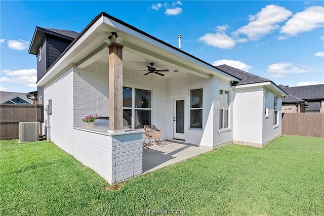 rear view of house featuring a lawn, ceiling fan, a patio area, and central air condition unit