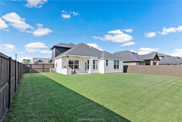 rear view of house featuring a lawn