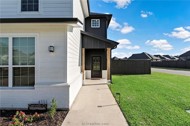 property entrance with a yard