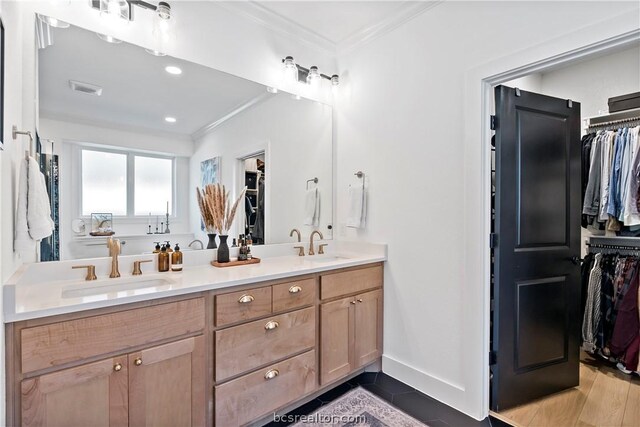 bathroom with vanity, ornamental molding, and hardwood / wood-style flooring