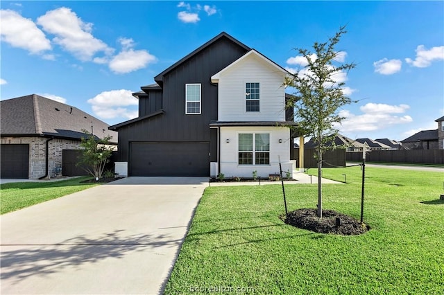 view of front of property featuring a garage and a front lawn