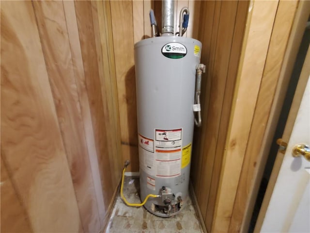 utility room featuring water heater