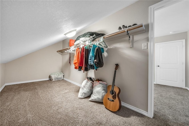 spacious closet featuring vaulted ceiling and carpet