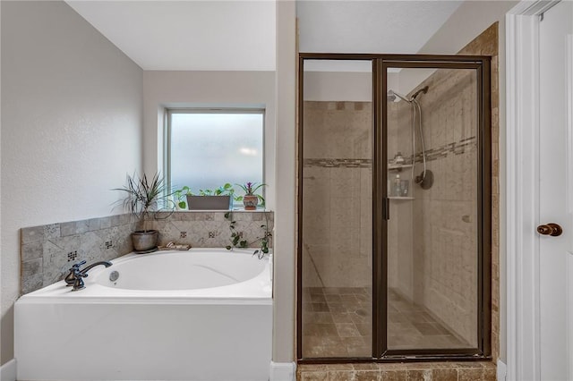 full bath featuring a garden tub and a shower stall