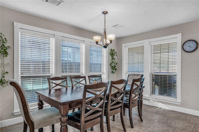 dining room featuring visible vents, baseboards, a notable chandelier, and tile patterned flooring