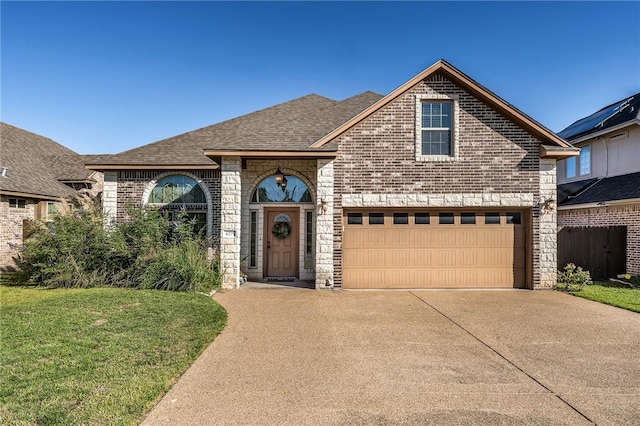 view of front of property with brick siding, driveway, a front yard, and roof with shingles