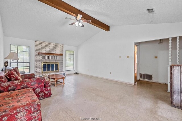 living room featuring high vaulted ceiling, ceiling fan, a fireplace, a textured ceiling, and beamed ceiling