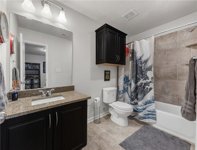 full bathroom featuring vanity, tile patterned floors, shower / bath combination with curtain, and toilet