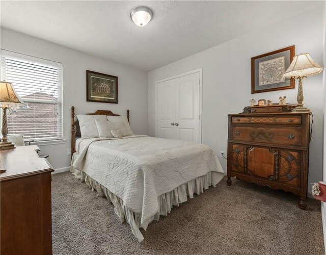 bedroom featuring dark carpet and a closet