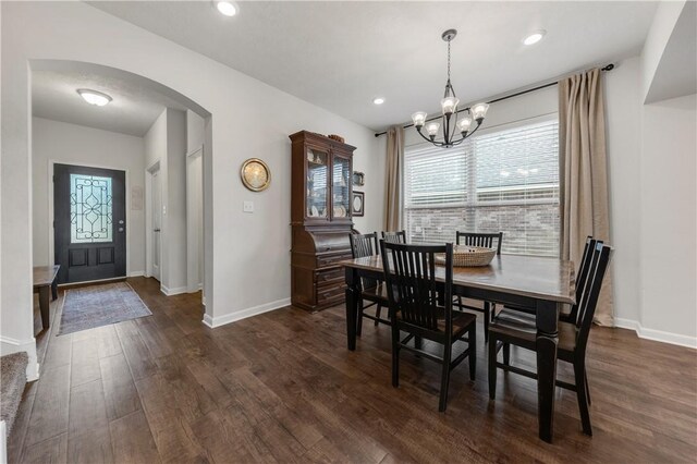 dining room featuring dark hardwood / wood-style floors and a chandelier