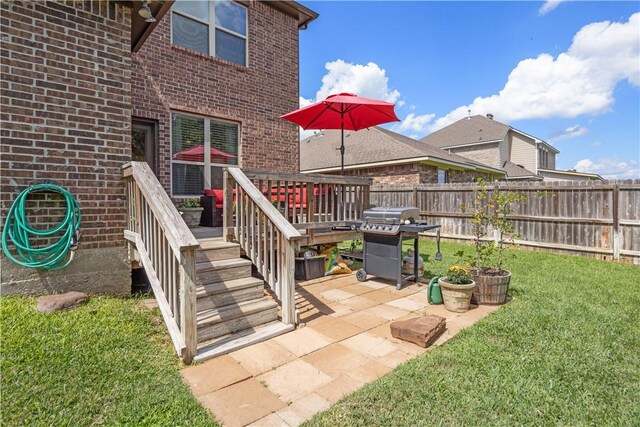 exterior space featuring a wooden deck and a patio