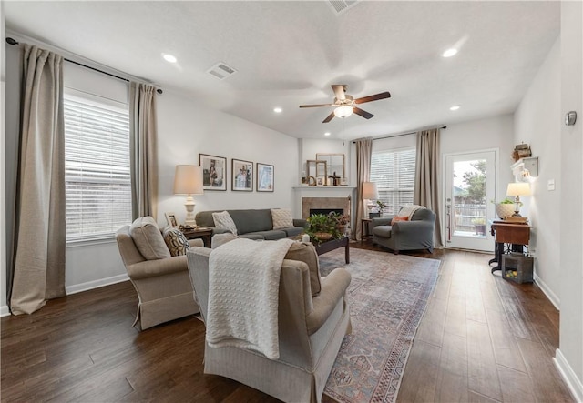 living room featuring dark hardwood / wood-style floors, plenty of natural light, and ceiling fan