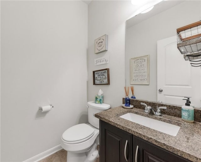 bathroom with vanity, tile patterned floors, and toilet