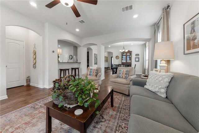 living room with dark hardwood / wood-style floors and ceiling fan