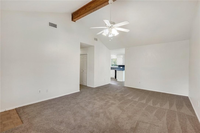 empty room featuring ceiling fan, beam ceiling, carpet floors, and high vaulted ceiling