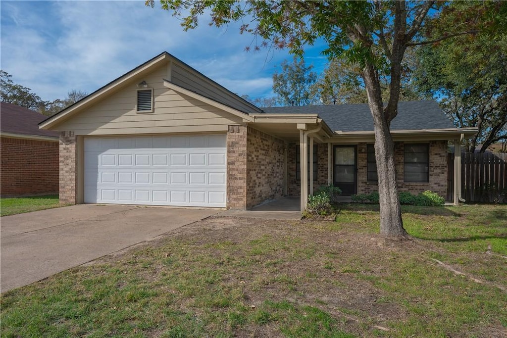 single story home featuring a front yard and a garage