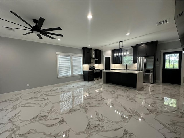 kitchen with decorative light fixtures, a center island, stainless steel appliances, and crown molding