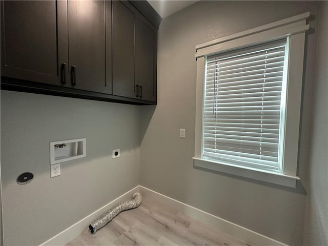 laundry room featuring electric dryer hookup, washer hookup, cabinets, and hardwood / wood-style flooring