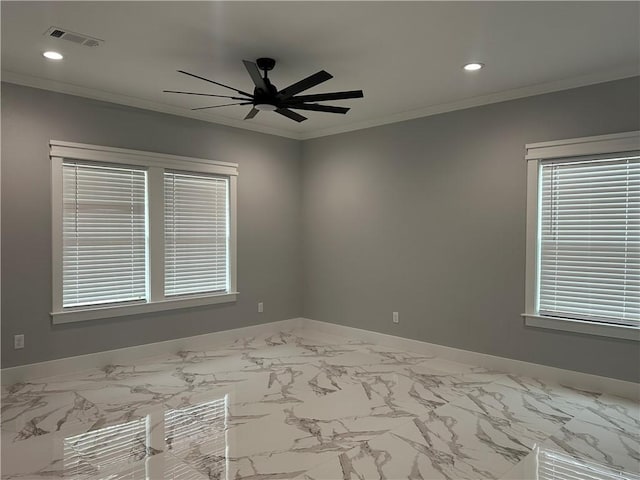 spare room featuring ceiling fan and ornamental molding