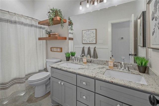 full bathroom with toilet, curtained shower, double vanity, and a sink