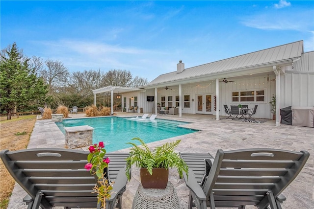 outdoor pool with a patio area, ceiling fan, a pergola, and french doors