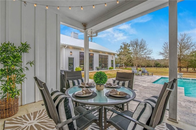 view of patio / terrace with outdoor dining area and an outdoor pool