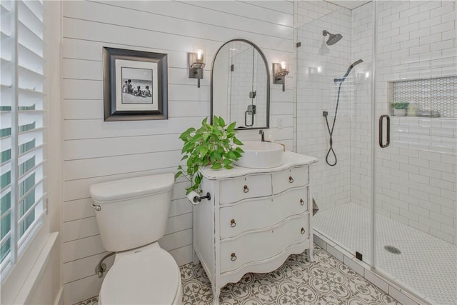 bathroom with toilet, a shower stall, vanity, and tile patterned floors