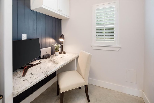 office featuring built in study area and baseboards