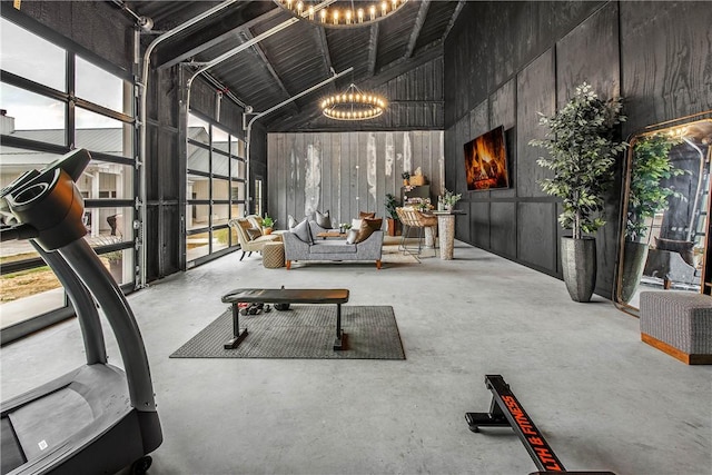 exercise area featuring high vaulted ceiling