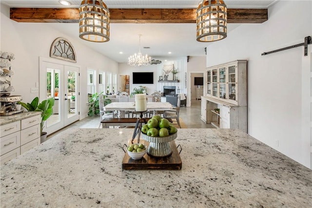 dining area with french doors, a fireplace, recessed lighting, a barn door, and beamed ceiling