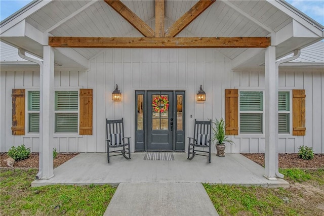 entrance to property with covered porch and board and batten siding