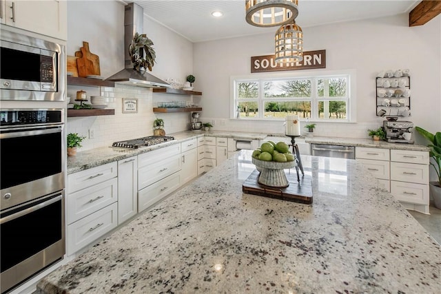 kitchen with open shelves, backsplash, appliances with stainless steel finishes, white cabinetry, and wall chimney exhaust hood