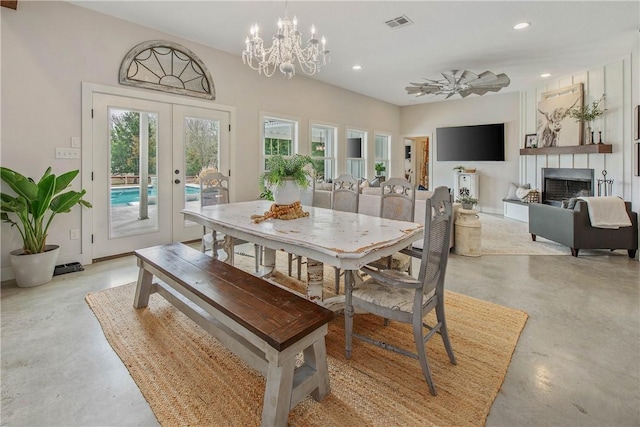 dining room with recessed lighting, concrete floors, a wealth of natural light, and french doors