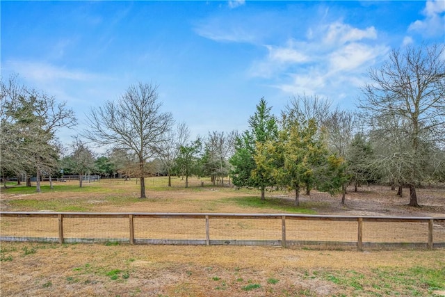 view of yard with a rural view and fence