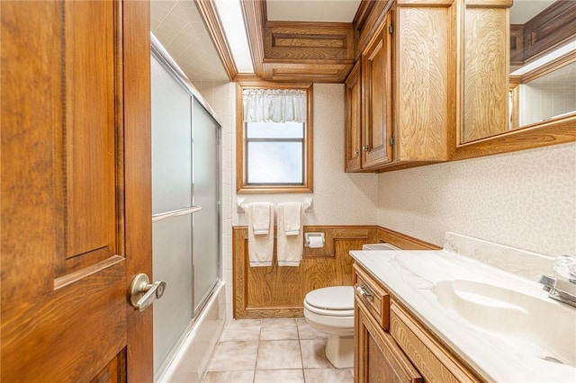 full bathroom featuring vanity, tile patterned floors, toilet, enclosed tub / shower combo, and ornamental molding