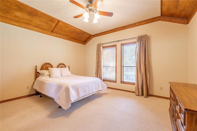 bedroom featuring light carpet, crown molding, ceiling fan, and lofted ceiling