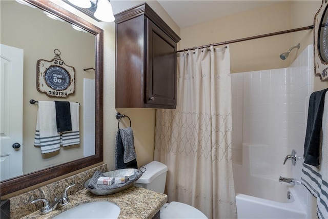 full bathroom with vanity, shower / tub combo, and toilet