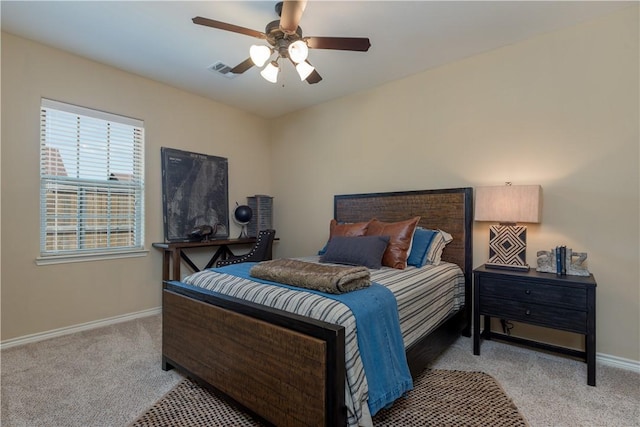bedroom with visible vents, a ceiling fan, baseboards, and light carpet