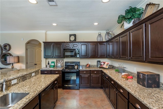 kitchen with dark brown cabinetry, a sink, arched walkways, visible vents, and black appliances