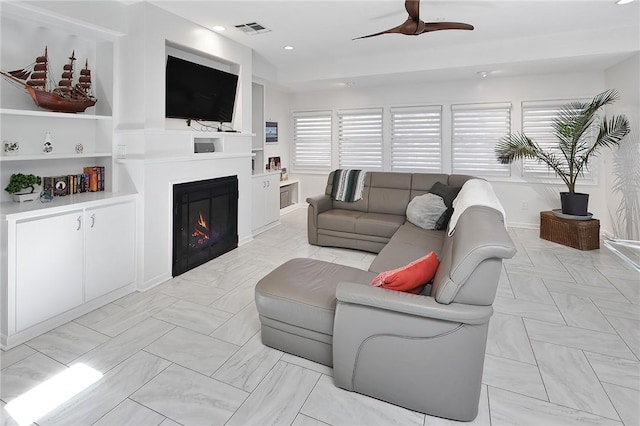 1013 Winding Rd, College Station, TX 77840 - living area with a ceiling fan, a glass covered fireplace, visible vents, and recessed lighting