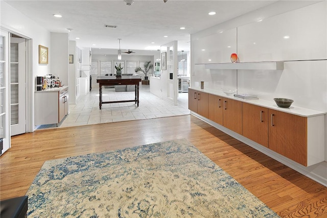 1013 Winding Rd, College Station, TX 77840 - interior space with light countertops, visible vents, and light wood-style flooring