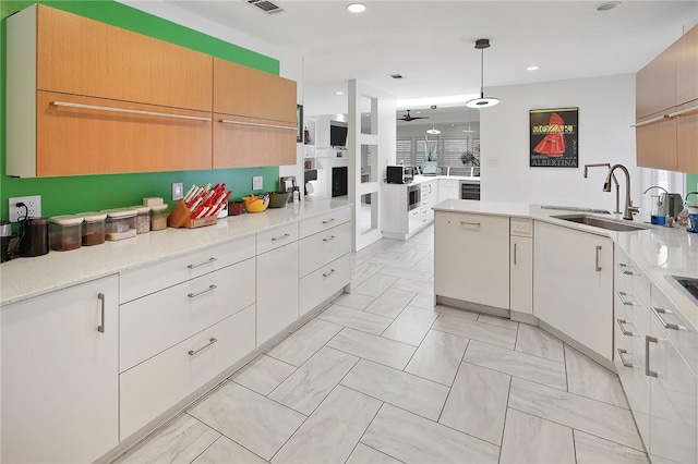 1013 Winding Rd, College Station, TX 77840 - kitchen featuring a peninsula, visible vents, light countertops, and a sink