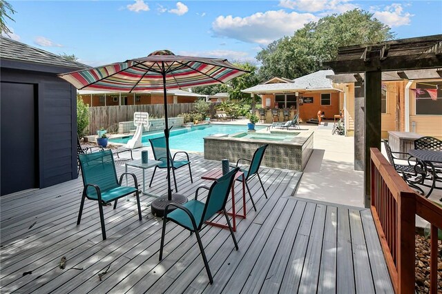 1013 Winding Rd, College Station, TX 77840 - wooden terrace with a fenced in pool, a storage structure, fence, an outdoor structure, and outdoor dining space